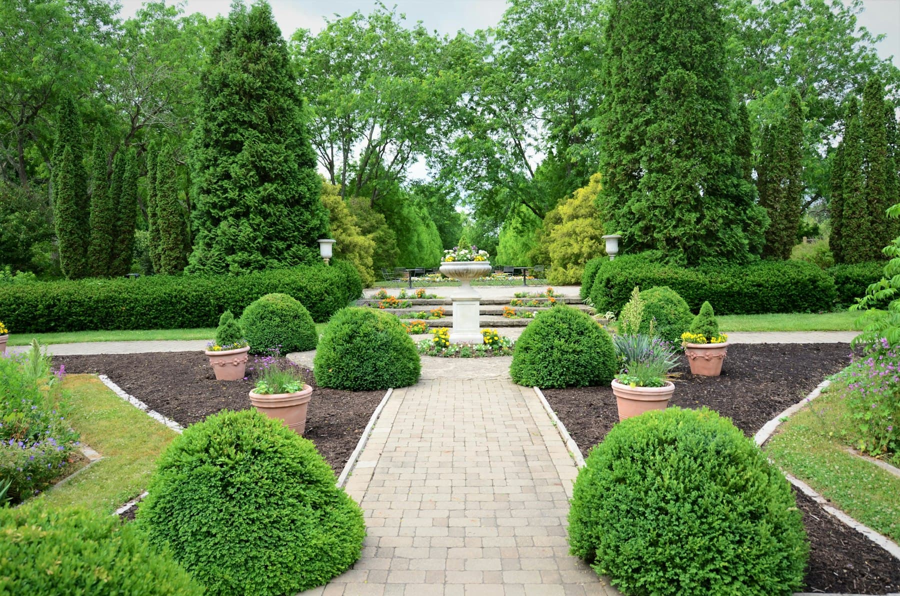 Fresh landscape installation with paver walkway, new plantings, and mulch beds